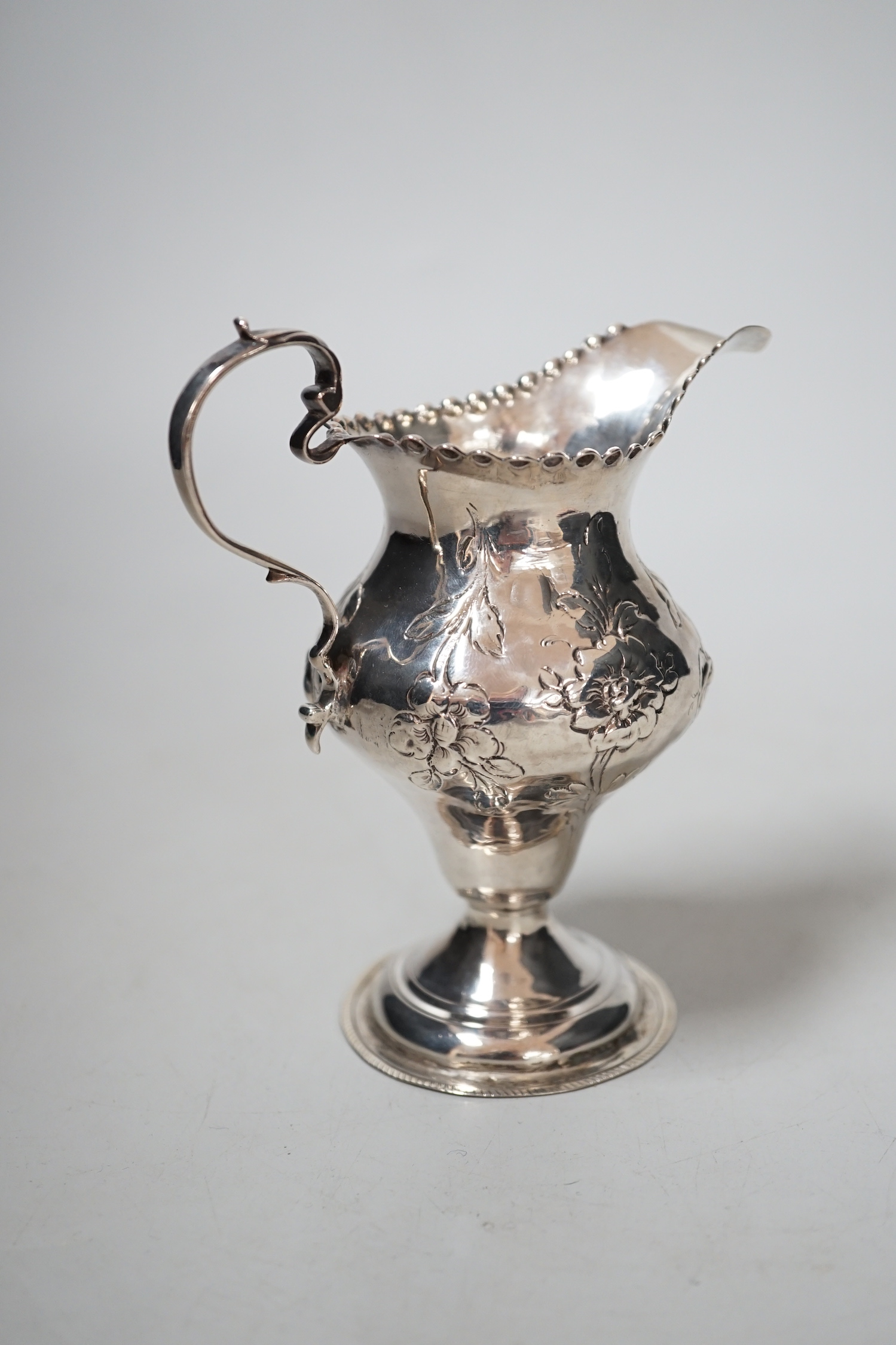 A George III silver inverted pear shaped cream jug, maker H?, London, 11.2cm, 75 grams.